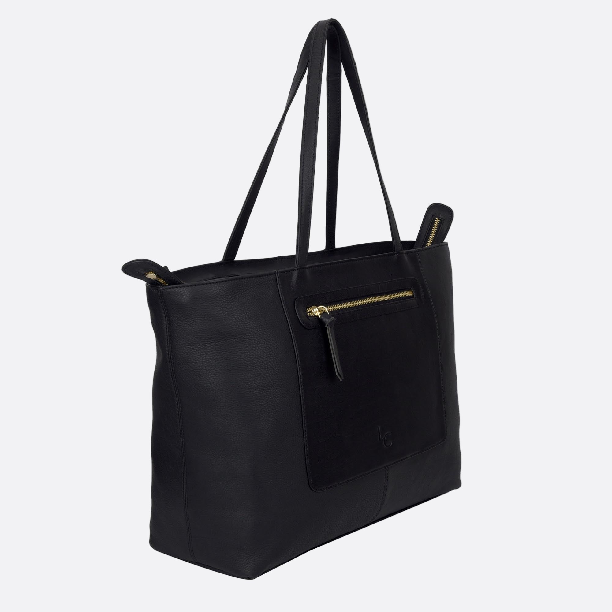 Side angle of NORRA large black leather tote showing depth and flat base