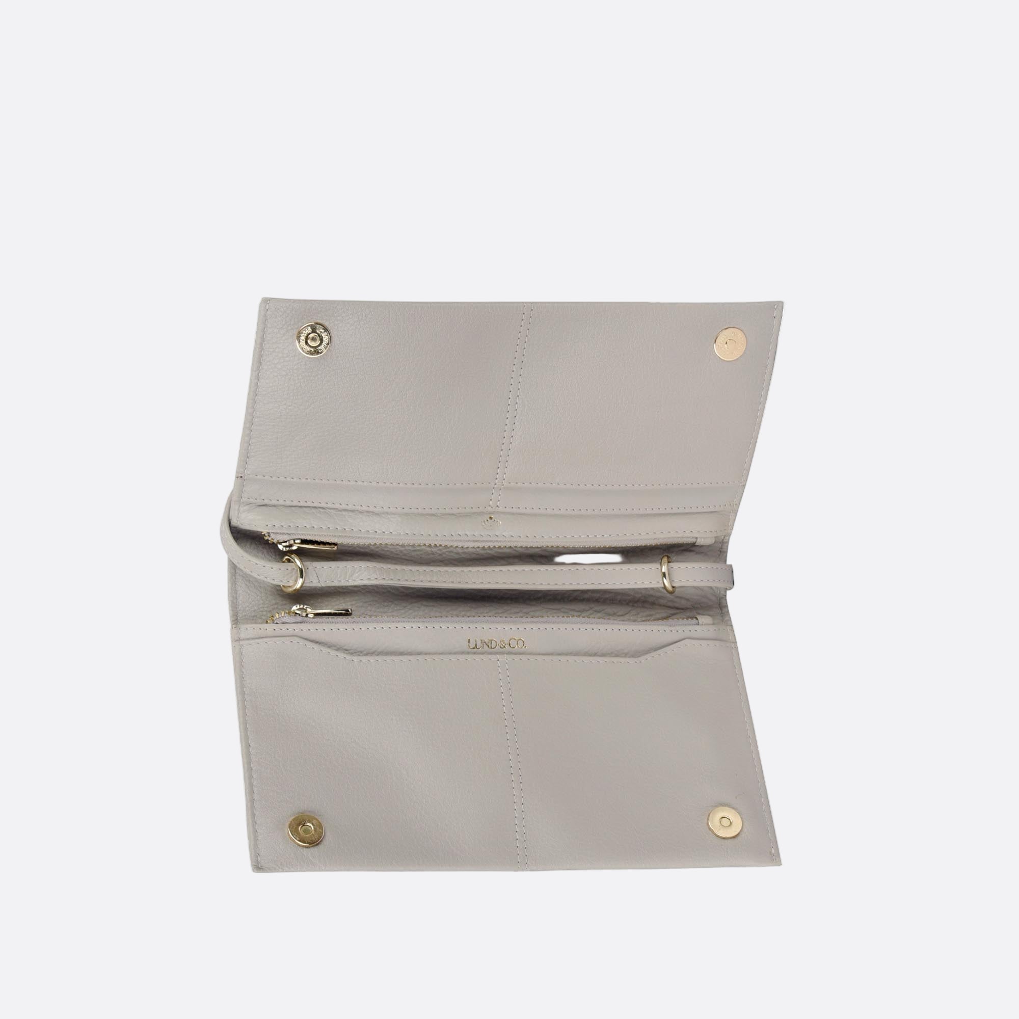 Open view of SOMMARLOV beige leather clutch showing internal compartments