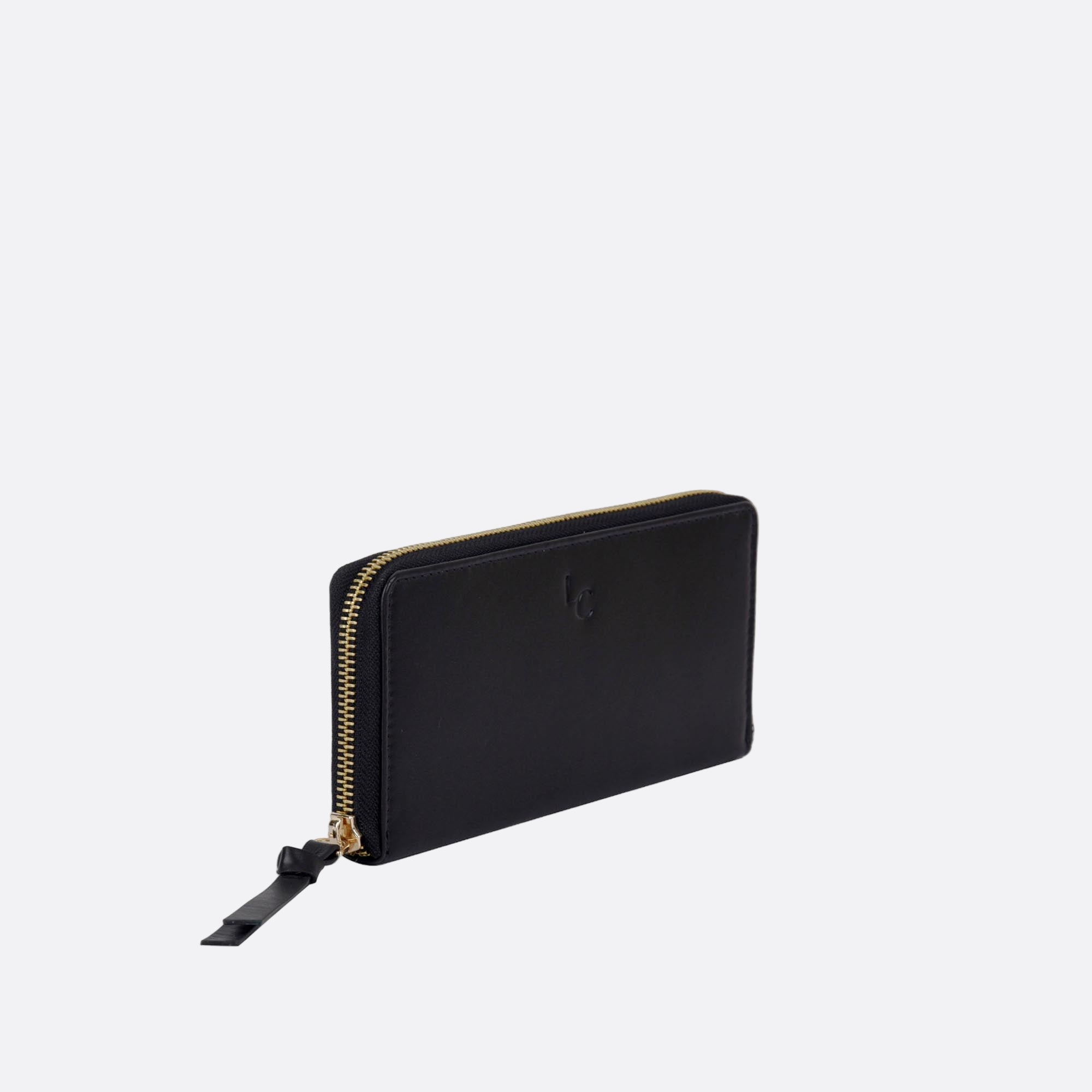 Side view of ANNA black leather wallet on light surface
