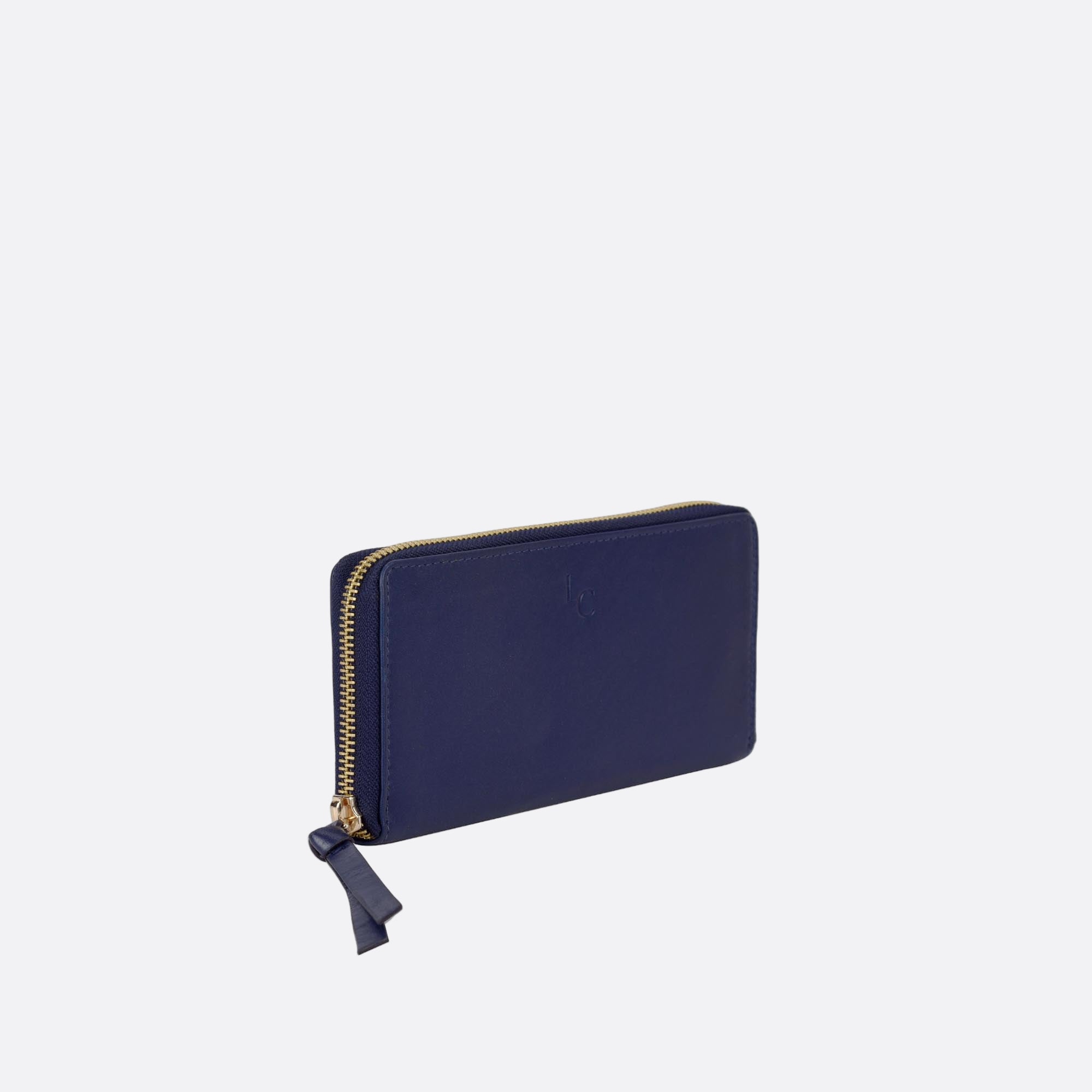 Side view of ANNA blue leather wallet on light surface

