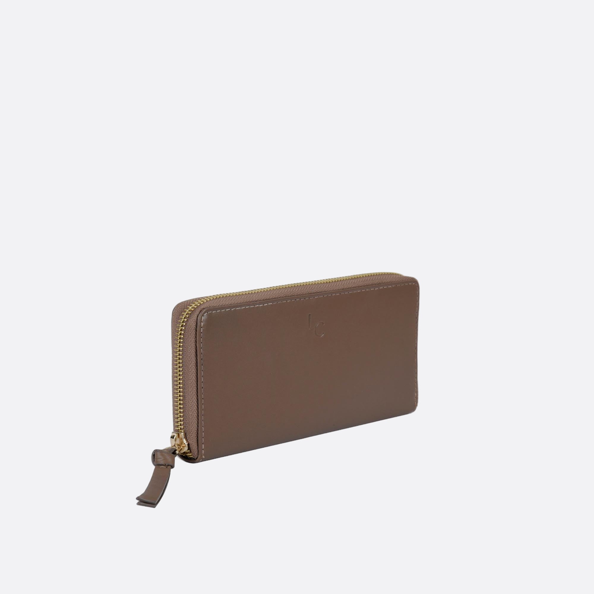 Side view of ANNA taupe leather wallet on light surface