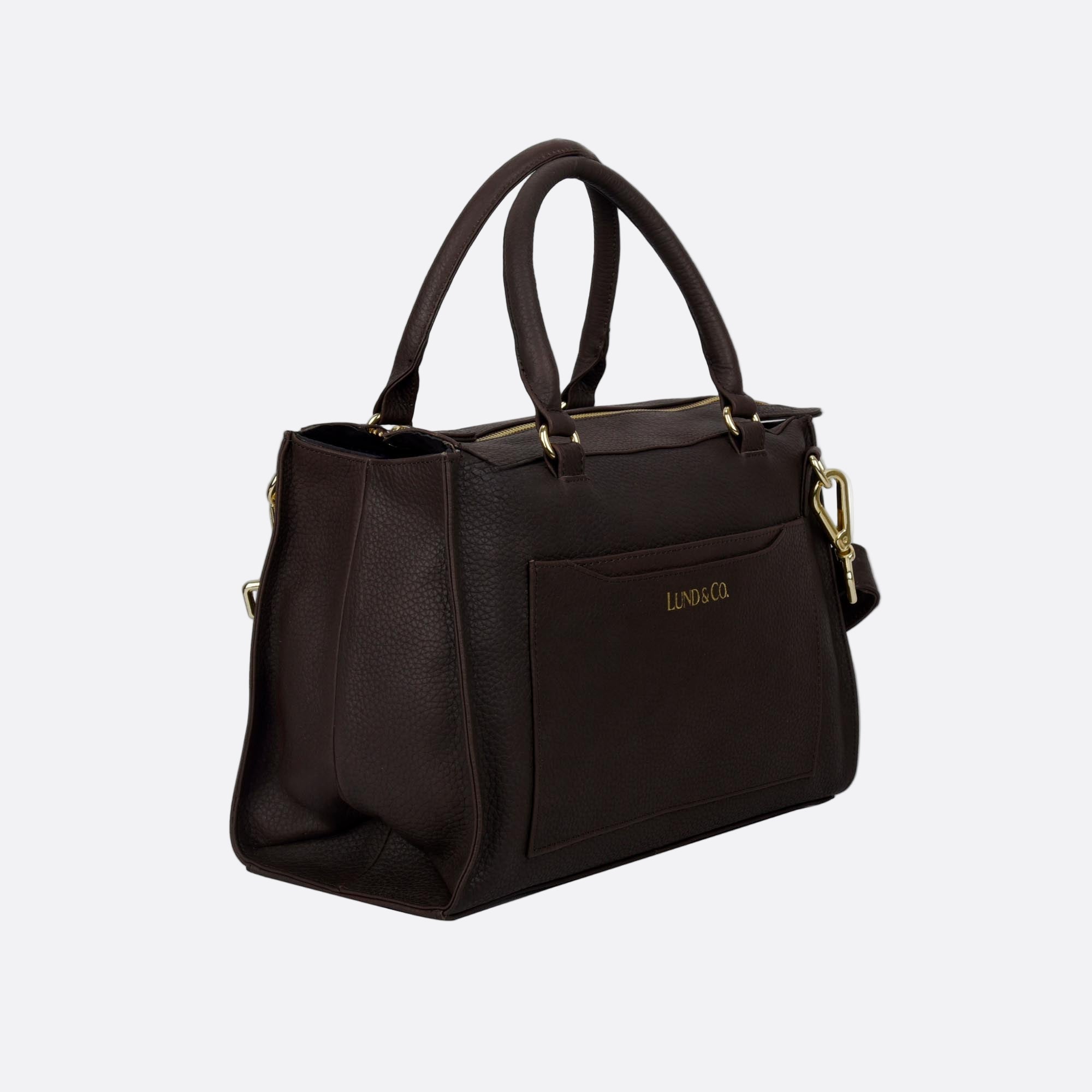 Side angle of BJORK brown leather tote showing side tailoring and base depth