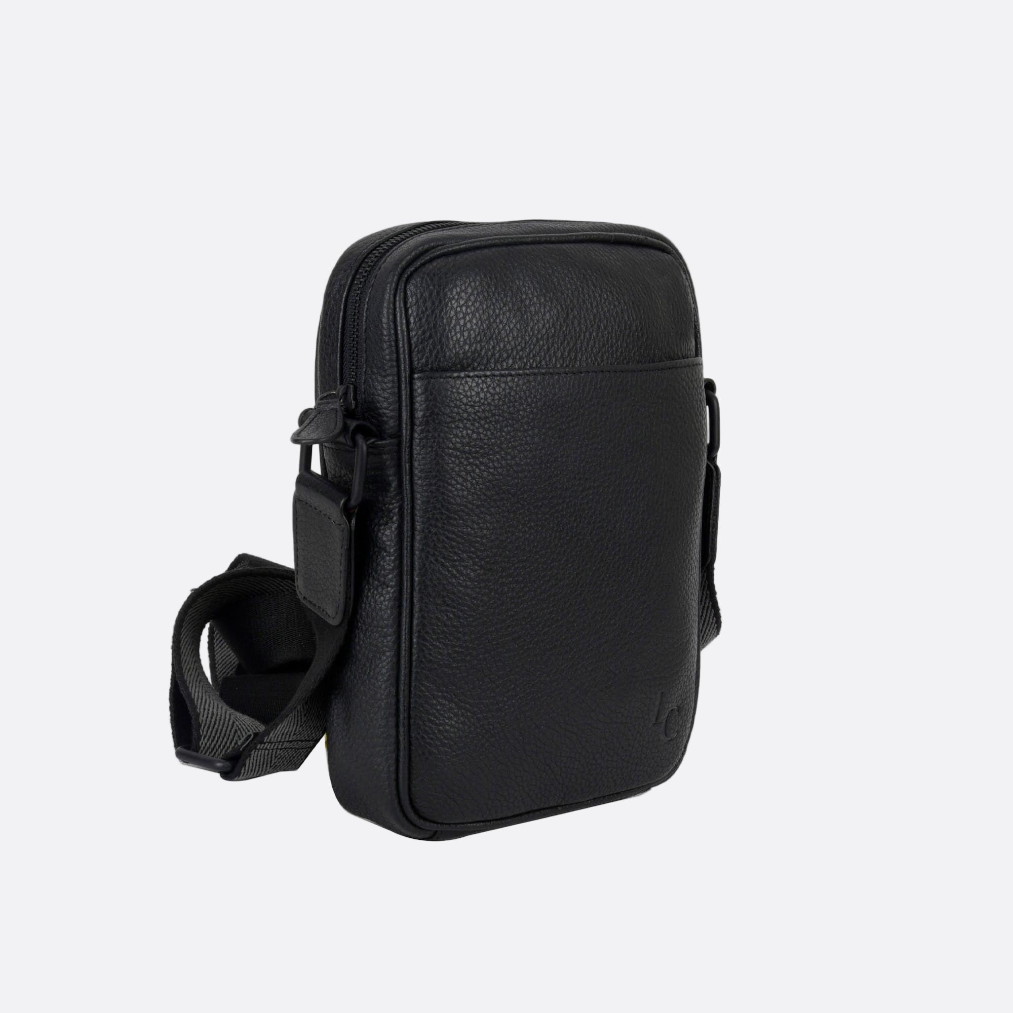 Side angle of KAFFE black leather bag showing slim profile and adjustable strap