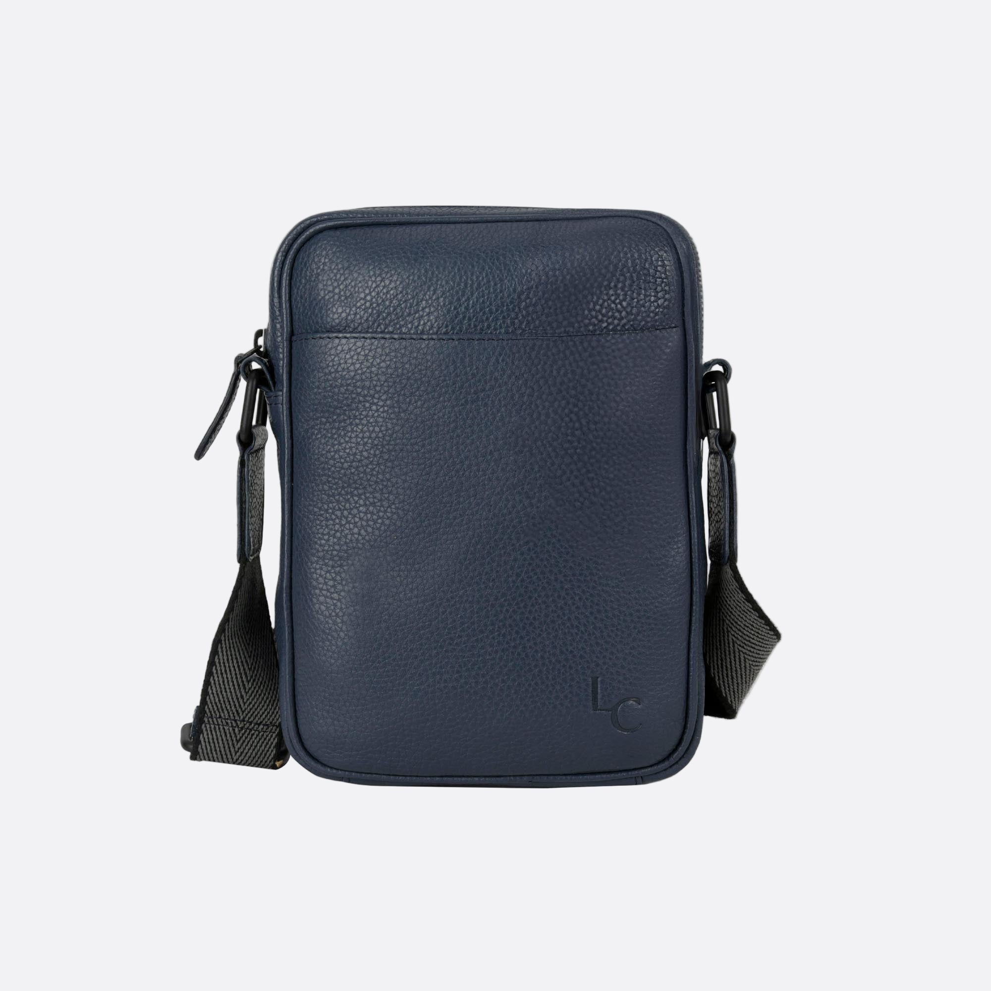 Front view of KAFFE small blue leather crossbody bag with zip closure and front slip pocket.