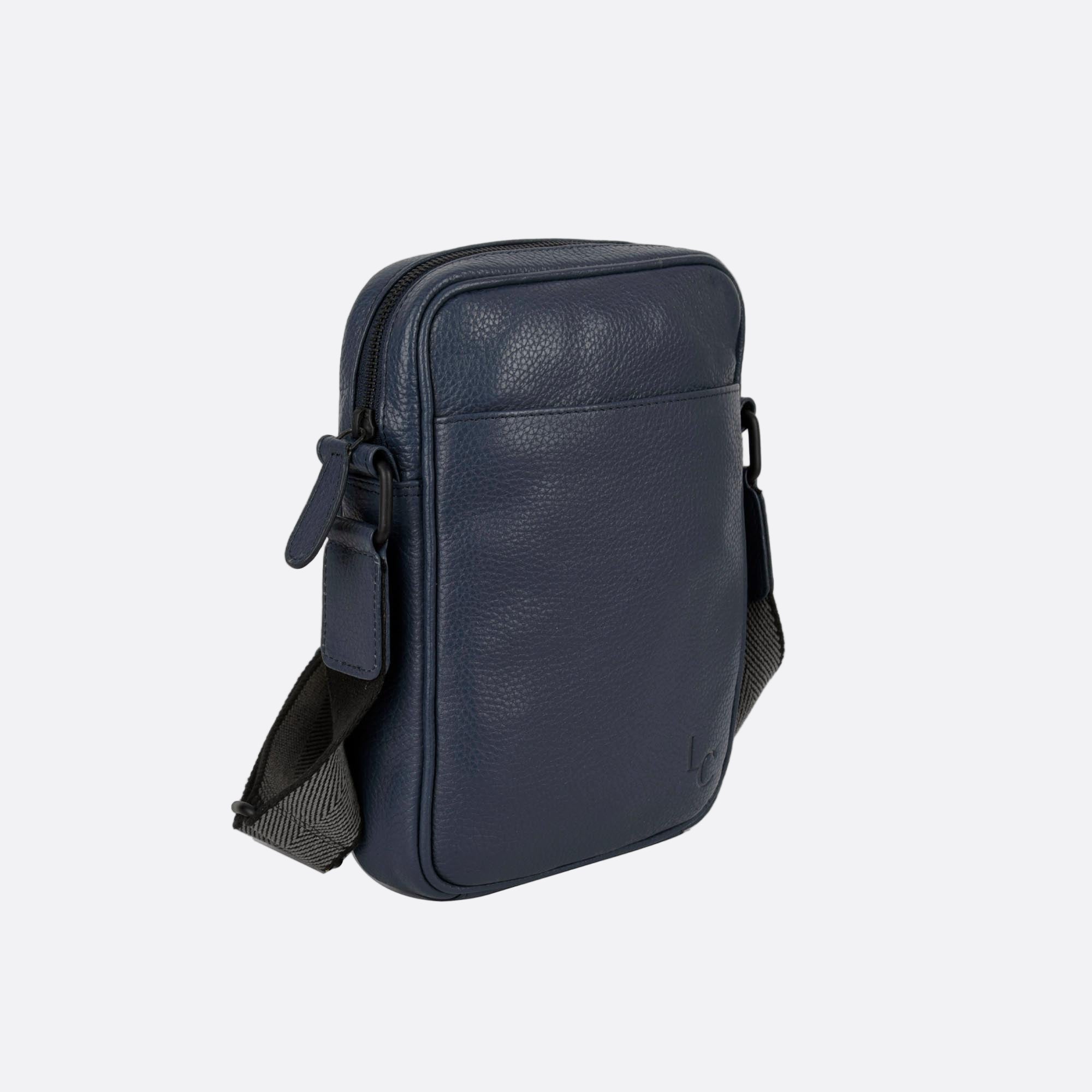 Side angle of KAFFE blue leather bag showing slim profile and adjustable strap