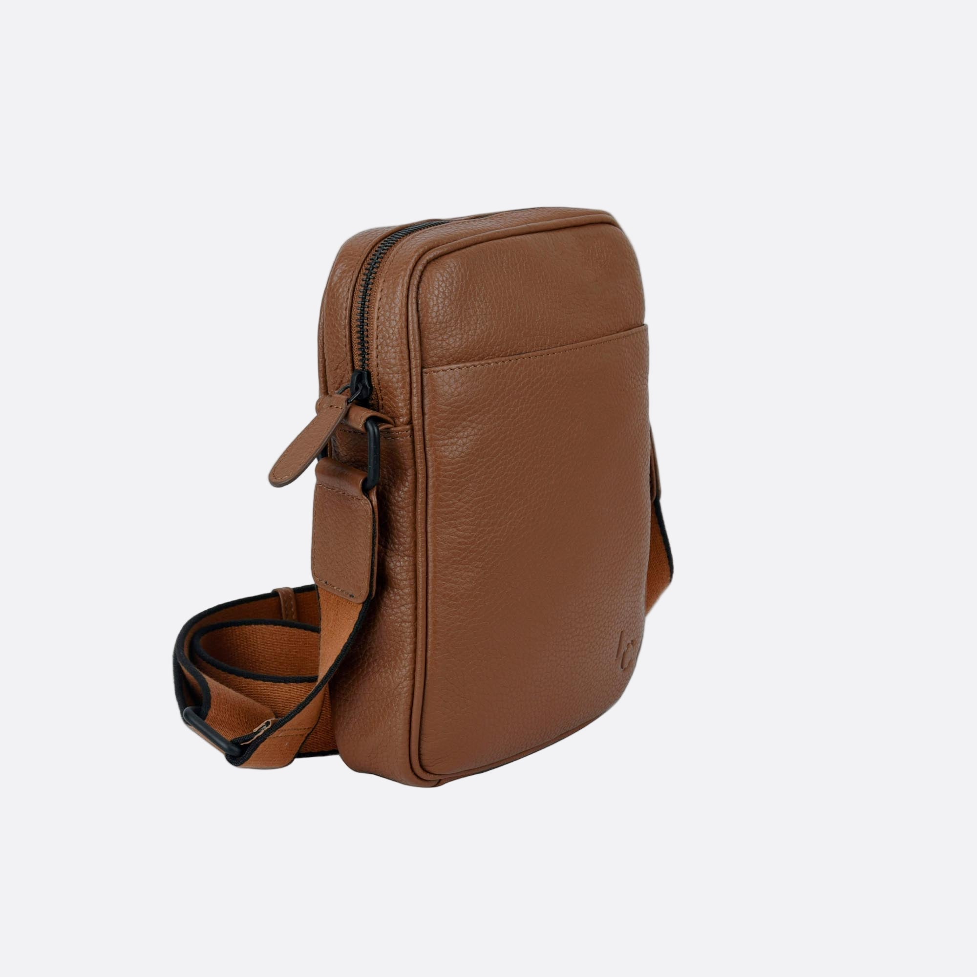 Side angle of KAFFE tan leather bag showing slim profile and adjustable strap