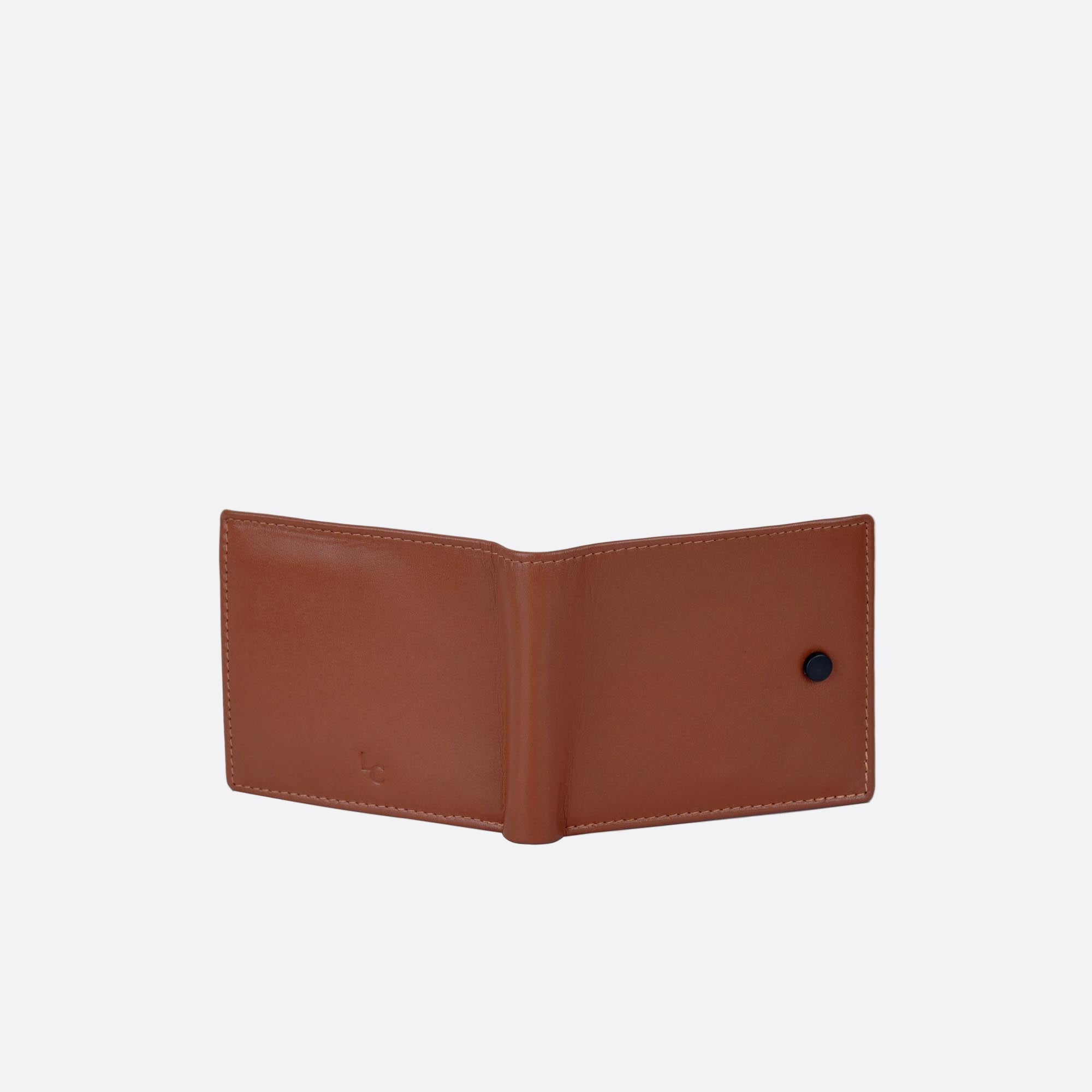Open back of KNAPP tan leather wallet black button detail