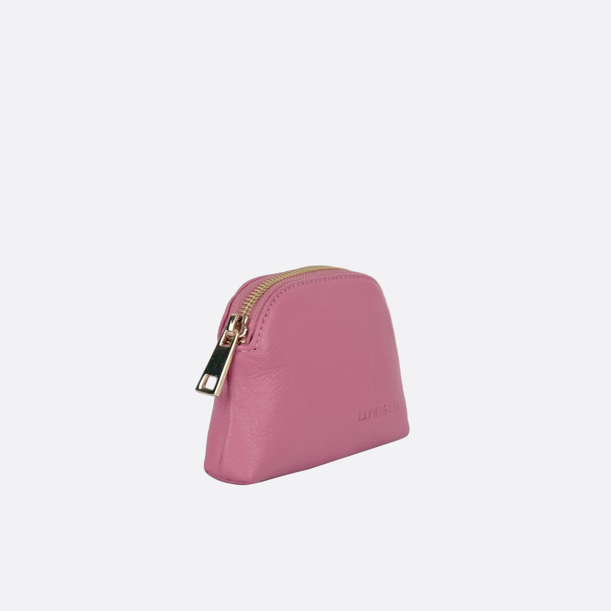 Side angle of LILLA-S pink leather dome purse showing slim profile and zip closure