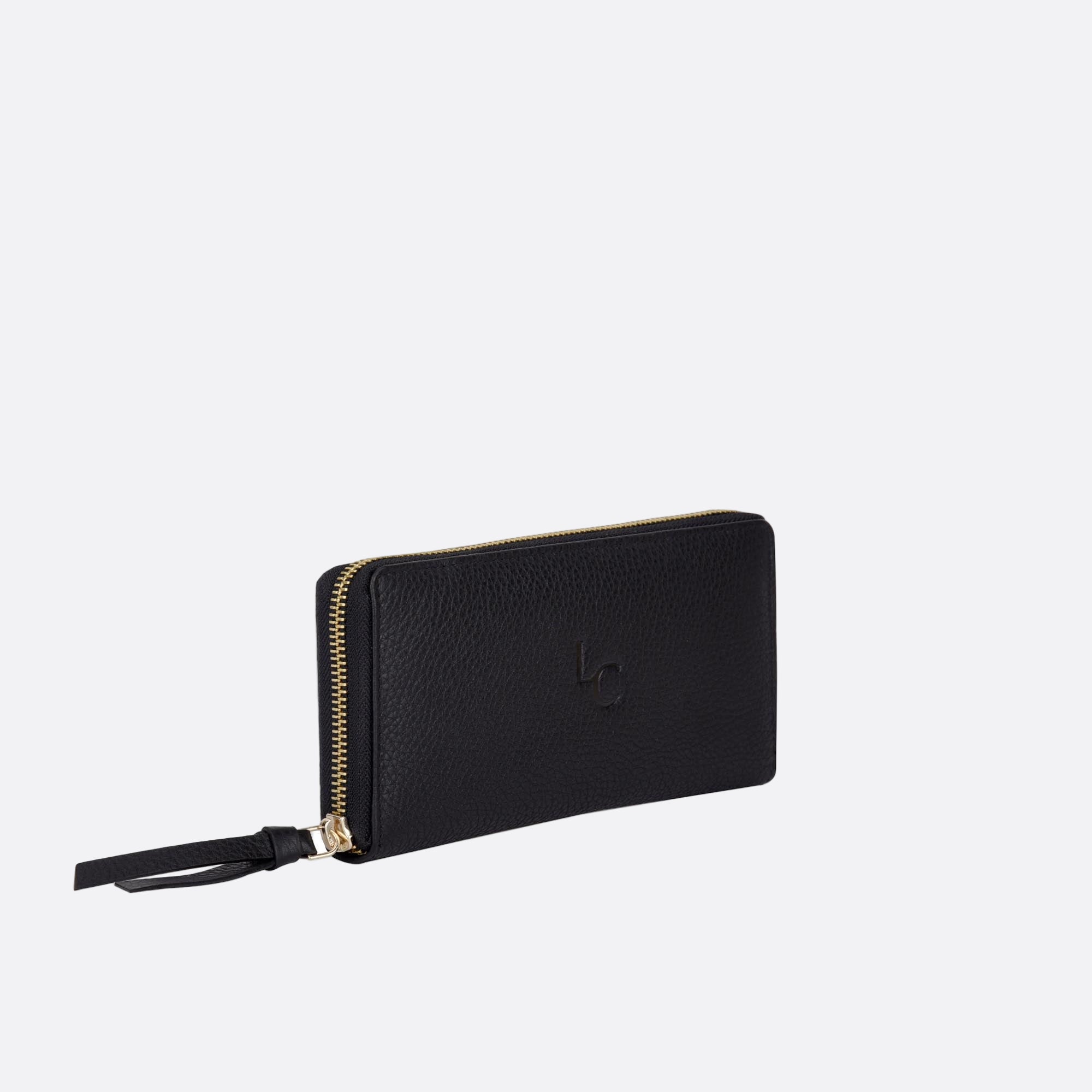 Side angle of MYNT large black leather wallet showing slim profile and zip closure