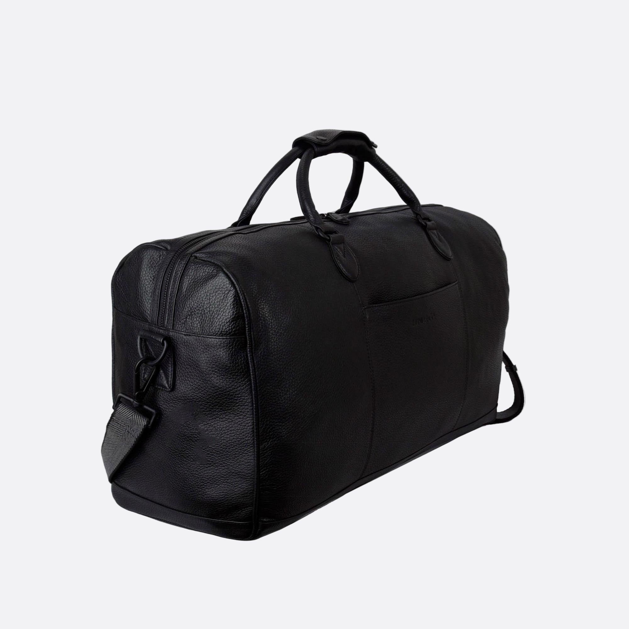 Side angle of OLLE black leather duffel bag showing depth and sturdy handles